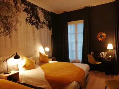 Un ou plusieurs lits dans un hébergement de l'établissement Hotel Du Cygne Tours