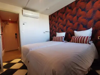 Un ou plusieurs lits dans un hébergement de l'établissement Hôtel Le Mercator