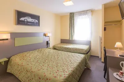 Un ou plusieurs lits dans un hébergement de l'établissement Pressoir Hôtel
