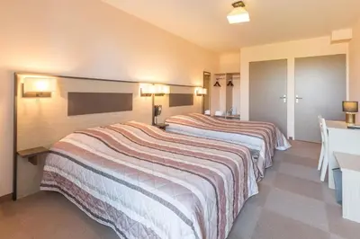 Un ou plusieurs lits dans un hébergement de l'établissement Pressoir Hôtel