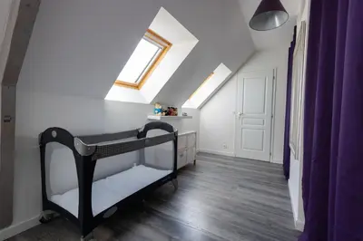 Un ou plusieurs lits dans un hébergement de l'établissement Appartement des Grands Champs avec terrasse