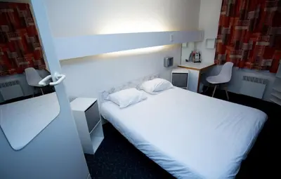 Un ou plusieurs lits dans un hébergement de l'établissement hôtel QUICK Palace Tours Nord
