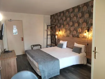 Un ou plusieurs lits dans un hébergement de l'établissement Hotel Au Sans Souci