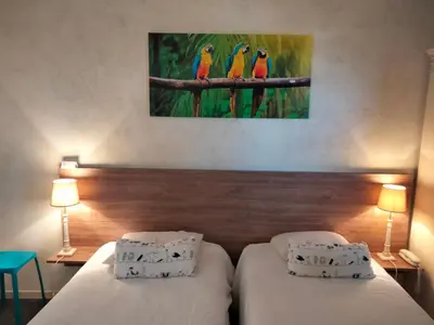 Un ou plusieurs lits dans un hébergement de l'établissement Hotel Au Sans Souci