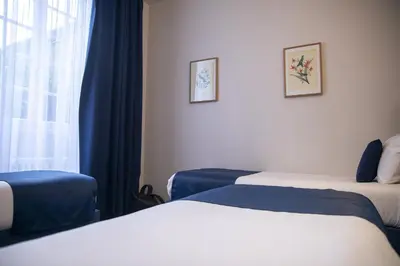 Un ou plusieurs lits dans un hébergement de l'établissement Hotel Beauvilliers