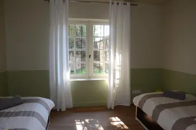 Un ou plusieurs lits dans un hébergement de l'établissement Gite Familial Chateau La Roche Racan