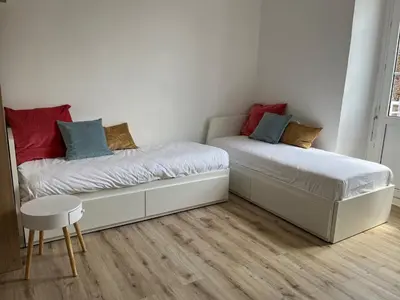 Un ou plusieurs lits dans un hébergement de l'établissement Appart'hôtel La Suze sur Sarthe
