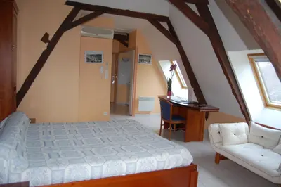 Un ou plusieurs lits dans un hébergement de l'établissement Appart'hôtel La Suze sur Sarthe