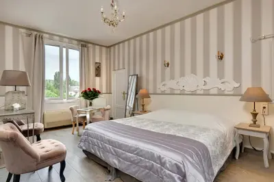 Un ou plusieurs lits dans un hébergement de l'établissement Hotel La Roseraie