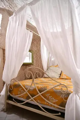 Un ou plusieurs lits dans un hébergement de l'établissement Les Gîtes des Châteaux, gîtes troglodytiques