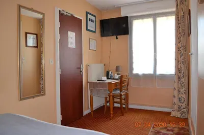 Un ou plusieurs lits dans un hébergement de l'établissement Hôtel Le Castel