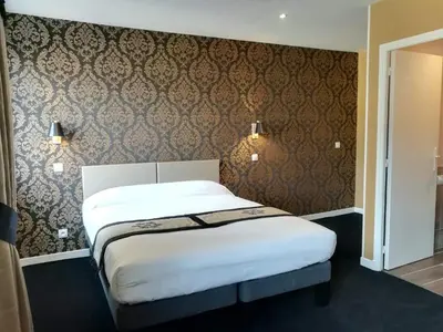 Un ou plusieurs lits dans un hébergement de l'établissement Logis Hôtel Auberge du Port des Roches