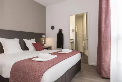 Un ou plusieurs lits dans un hébergement de l'établissement Appart'hôtel Odalys City - Le Mans Centre Palais des Congrès
