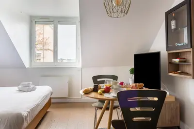 Un ou plusieurs lits dans un hébergement de l'établissement Appart Hotel NuitéeJour Le Mans Centre Jaurès