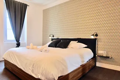 Un ou plusieurs lits dans un hébergement de l'établissement Appart Hotel NuitéeJour Le Mans Centre Jaurès