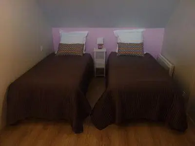 Un ou plusieurs lits dans un hébergement de l'établissement Jolie Maison de Campagne en pierre de tuffeau