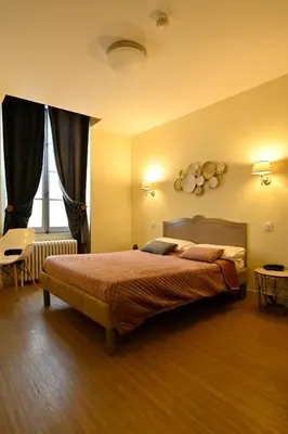 Un ou plusieurs lits dans un hébergement de l'établissement Hôtel Relais du Loir