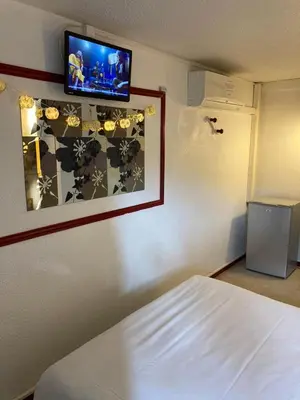 Un ou plusieurs lits dans un hébergement de l'établissement Nouvelle Classe Hotel