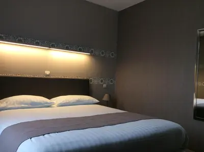 Un ou plusieurs lits dans un hébergement de l'établissement Hotel Berthelot