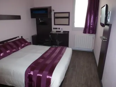Un ou plusieurs lits dans un hébergement de l'établissement Tourhotel Blois