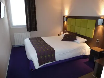 Un ou plusieurs lits dans un hébergement de l'établissement Tourhotel Blois