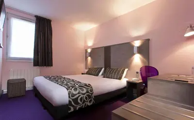 Un ou plusieurs lits dans un hébergement de l'établissement Tourhotel Blois