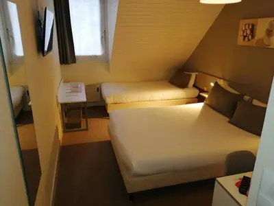 Un ou plusieurs lits dans un hébergement de l'établissement Tourhotel Blois