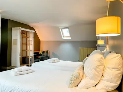 Un ou plusieurs lits dans un hébergement de l'établissement Gite de la Tour SPA PRIVÉ