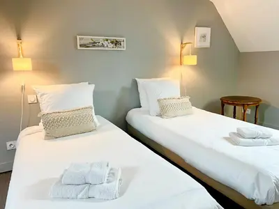 Un ou plusieurs lits dans un hébergement de l'établissement Gite de la Tour SPA PRIVÉ