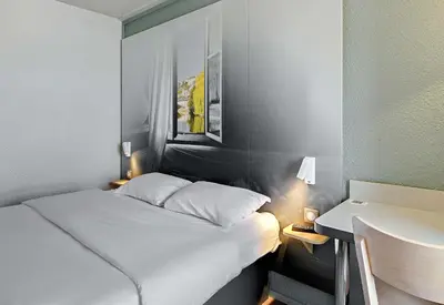 Un ou plusieurs lits dans un hébergement de l'établissement B&B HOTEL le Mans Centre