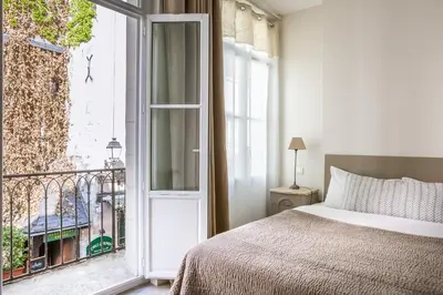 Un ou plusieurs lits dans un hébergement de l'établissement Hôtel L'Adresse