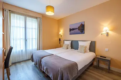 Un ou plusieurs lits dans un hébergement de l'établissement Hotel Val De Loire