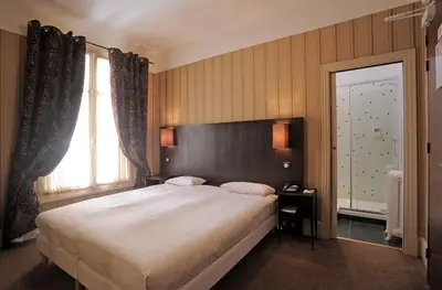 Un ou plusieurs lits dans un hébergement de l'établissement Le Grand Hotel