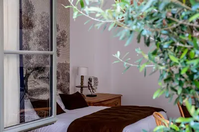 Un ou plusieurs lits dans un hébergement de l'établissement Maison Gaspard - Suites et appartements de charme à Saumur
