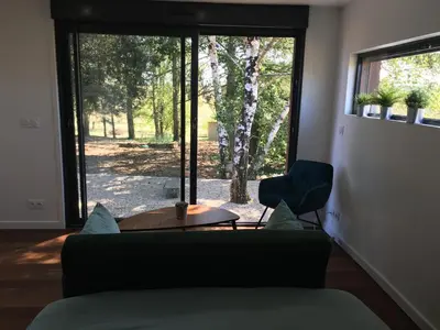 Coin salon dans l'établissement COTTAGE A LA FONTAINE DU CHENE