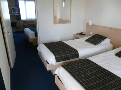 Un ou plusieurs lits dans un hébergement de l'établissement Hotel L'Océane Angers Parc Expo