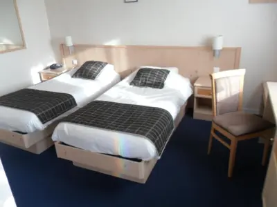 Un ou plusieurs lits dans un hébergement de l'établissement Hotel L'Océane Angers Parc Expo