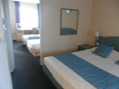 Un ou plusieurs lits dans un hébergement de l'établissement Hotel L'Océane Angers Parc Expo