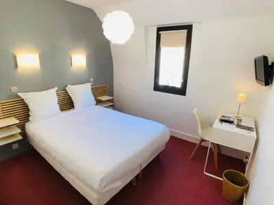 Un ou plusieurs lits dans un hébergement de l'établissement Cit'Hotel Le Volney