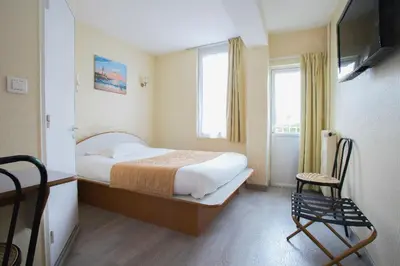Un ou plusieurs lits dans un hébergement de l'établissement Hotel De Rosny