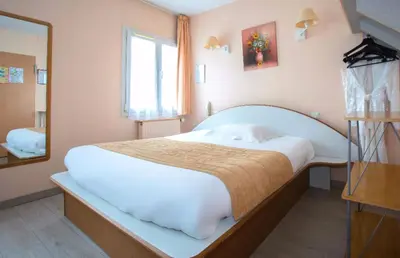 Un ou plusieurs lits dans un hébergement de l'établissement Hotel De Rosny