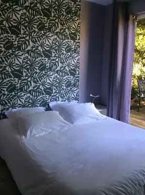 Un ou plusieurs lits dans un hébergement de l'établissement Les Cabanes de Do