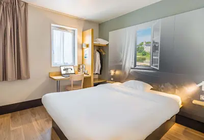 Un ou plusieurs lits dans un hébergement de l'établissement B&B HOTEL Tours Nord 2 La petite Arche
