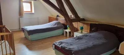 Un ou plusieurs lits dans un hébergement de l'établissement Grand gîte à la campagne