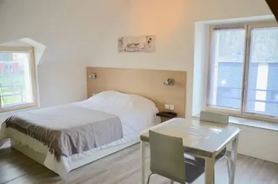 Un ou plusieurs lits dans un hébergement de l'établissement La petite maison appartement 2
