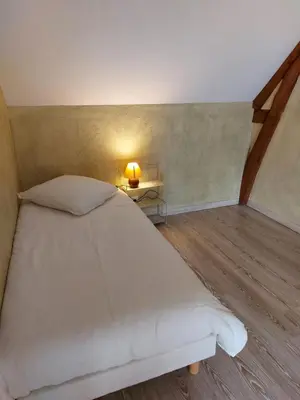 Un ou plusieurs lits dans un hébergement de l'établissement Traînefeuilles - Chambres d'hôtes proche Zoo de Beauval
