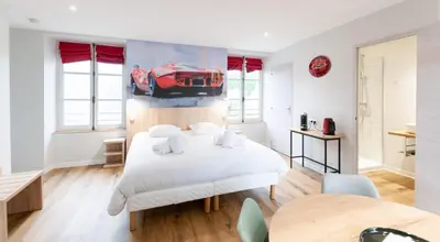 Un ou plusieurs lits dans un hébergement de l'établissement Malicorn' Appart-Hôtel