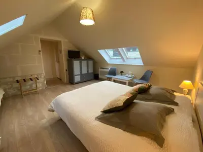 Un ou plusieurs lits dans un hébergement de l'établissement Les Mariniers Chambres d'Hôtes avec aire de jeux proche du ZooParc de Beauval - Spa nordique en option