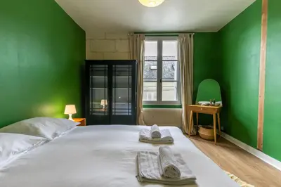 Un ou plusieurs lits dans un hébergement de l'établissement Chez Miriam - Maison de caractère - Ville avec jardin