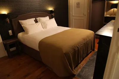 Un ou plusieurs lits dans un hébergement de l'établissement Hôtel Le Gentleman